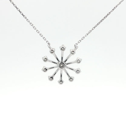 Silver snowflake pendant necklace on a white background